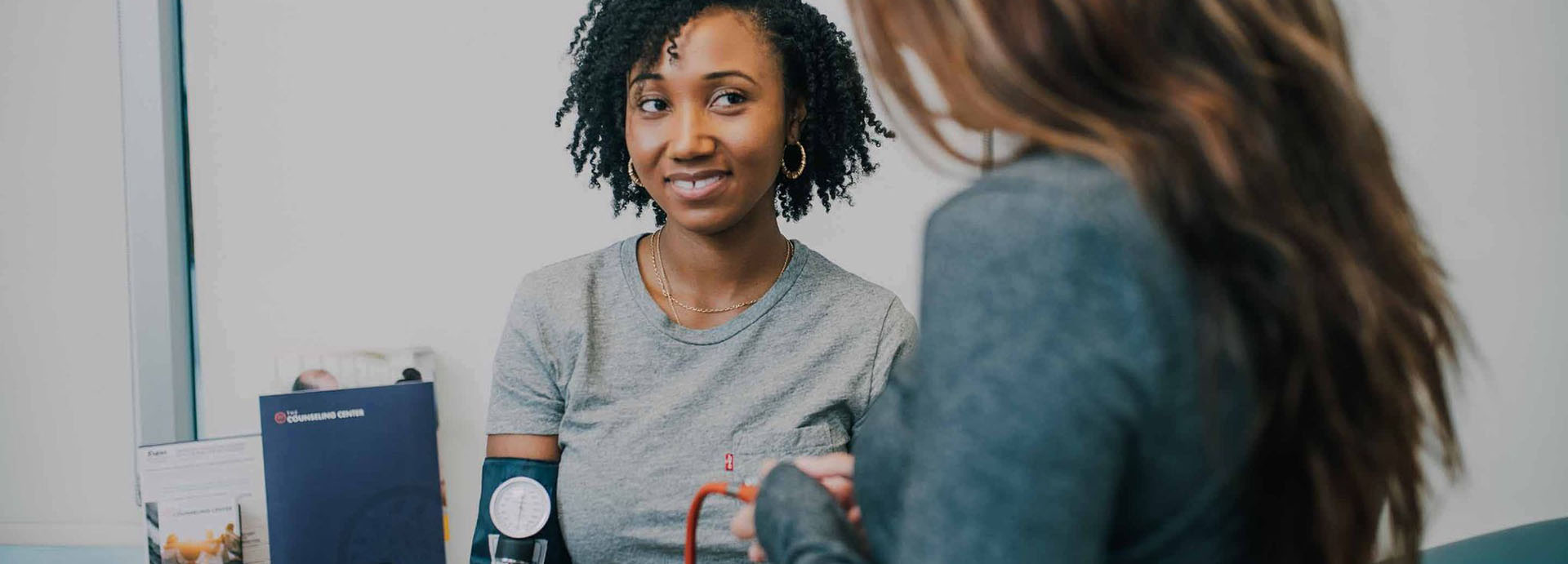 A medical professional taking a woman's blood pressure