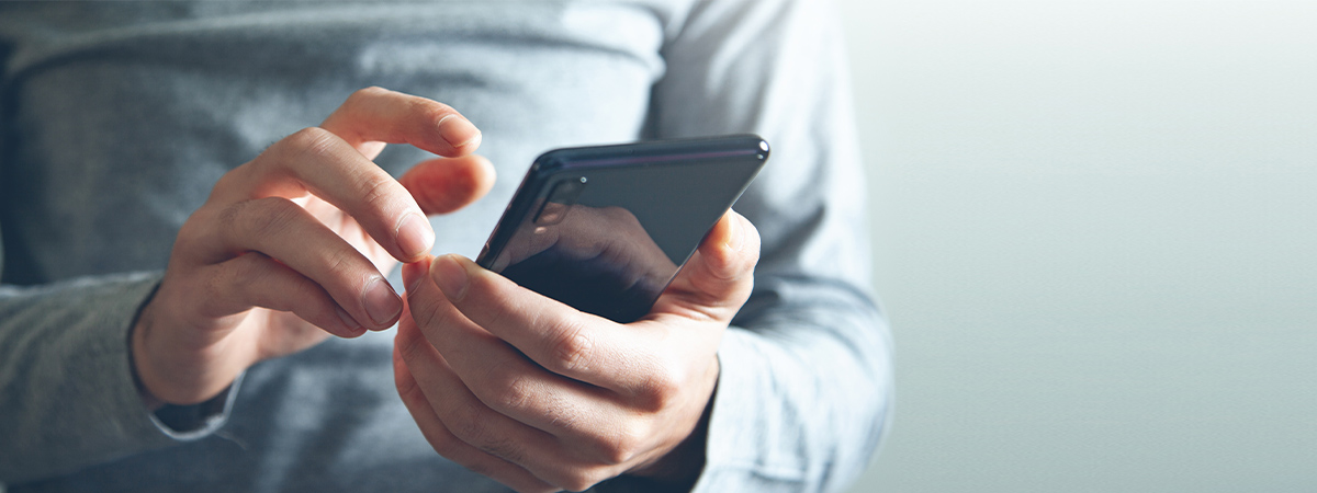 Close up shot of a man holding a cell phone