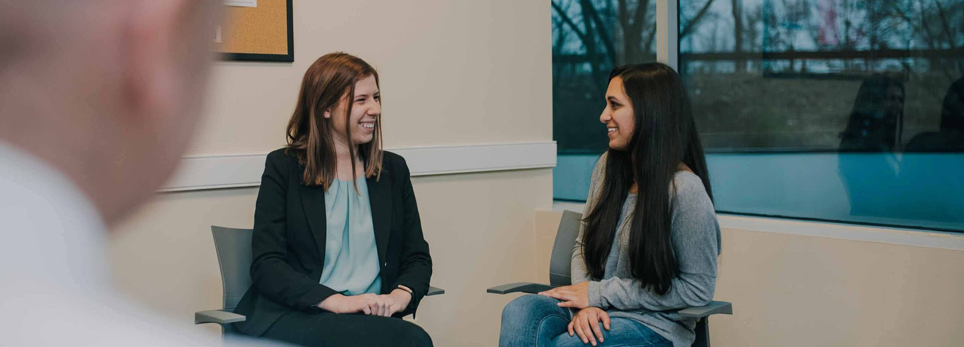 to women sitting down with a consoler