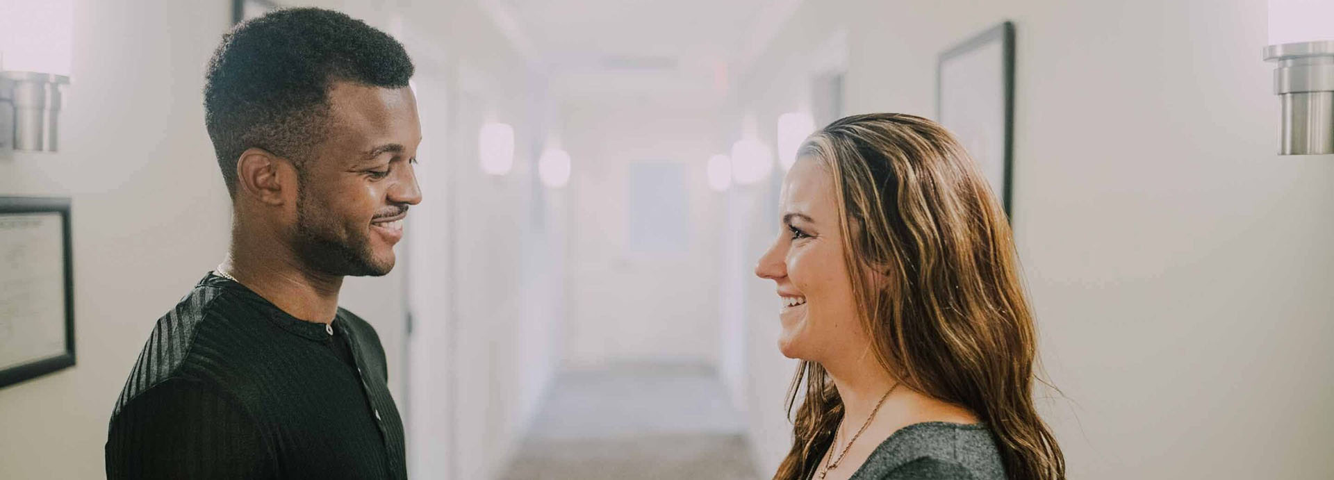 man and woman looking at each other smiling 