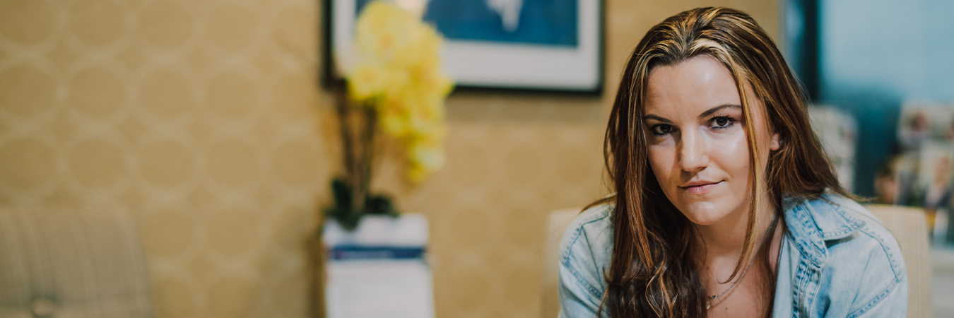 woman slightly smiling looking at the camera