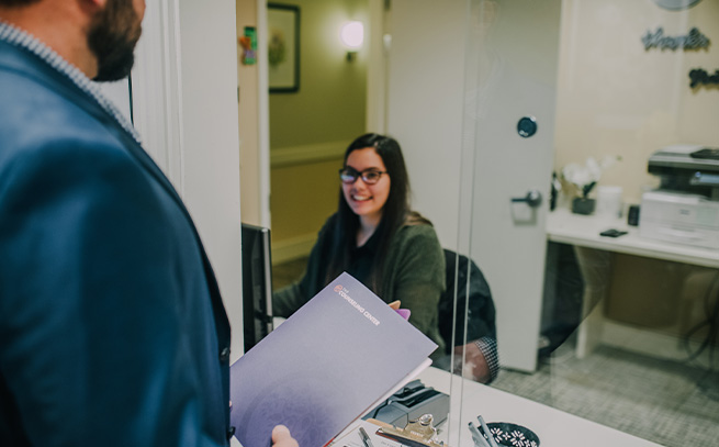 woman sitting down at desk smiling 