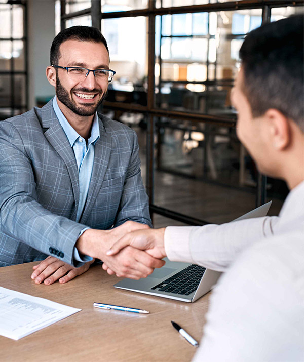 two men shacking hands in an office