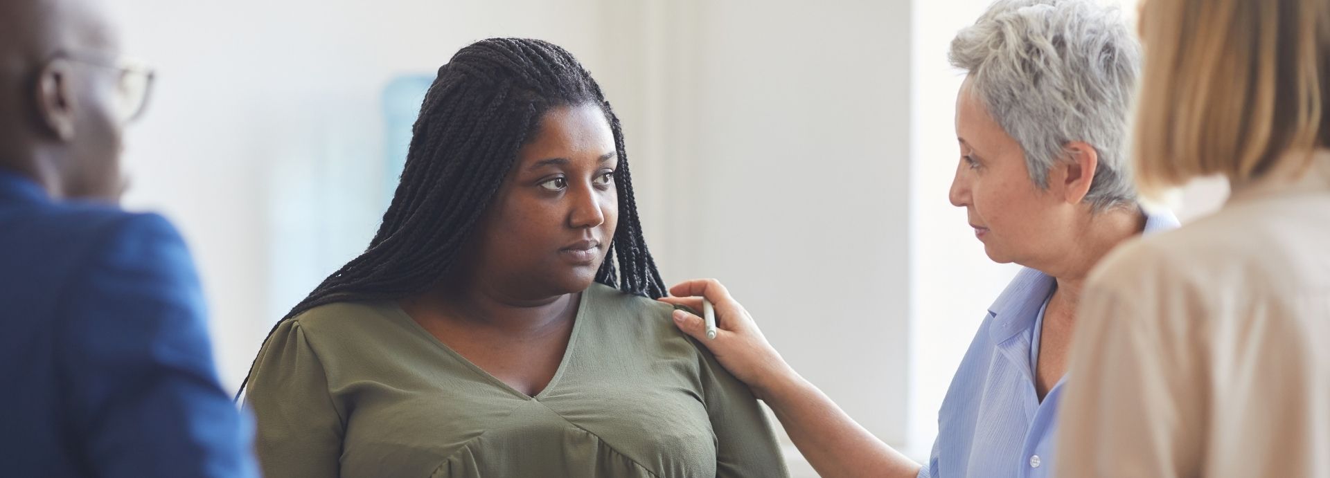 a woman in a consoling group
