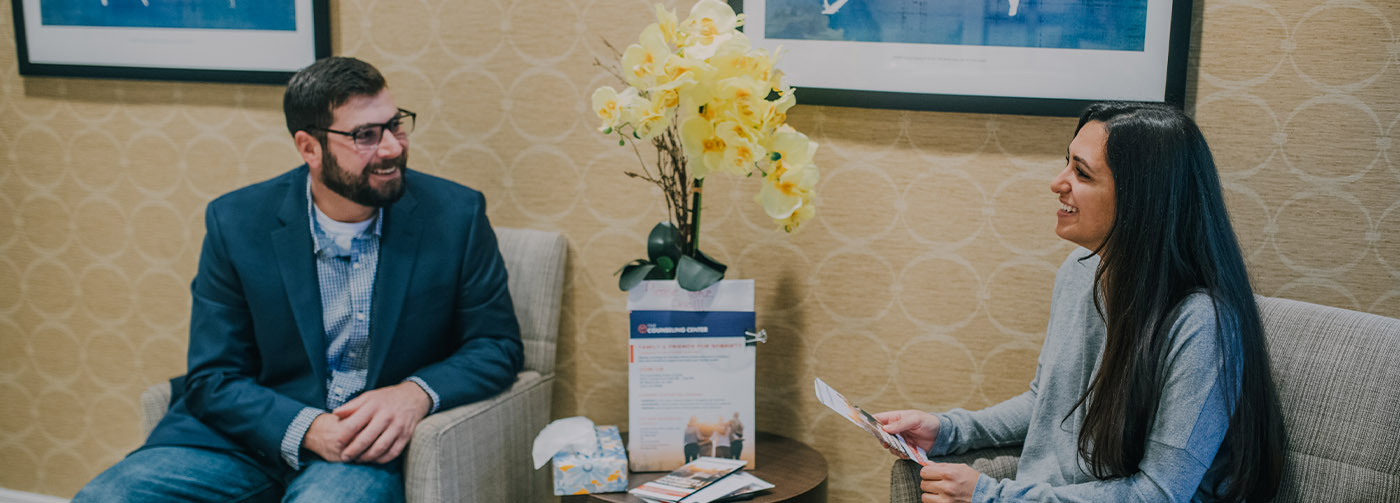 man and woman sitting down talking
